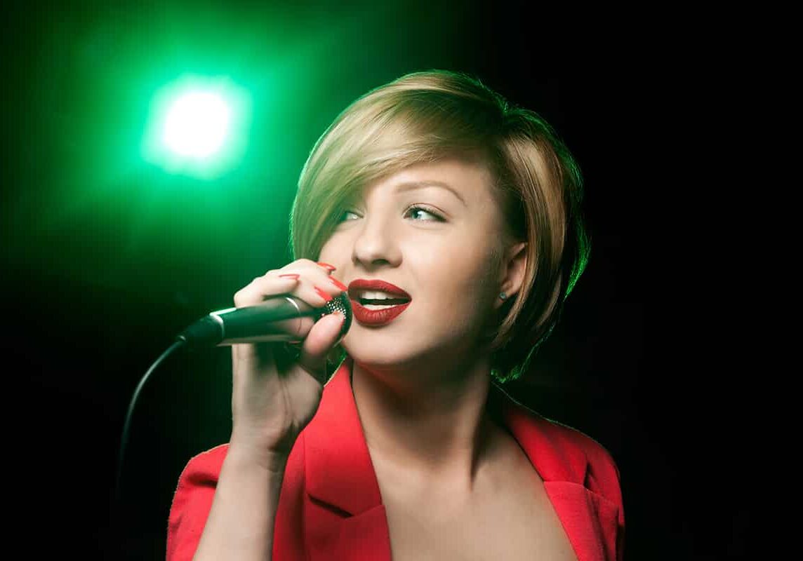 Singing woman with retro microphone.